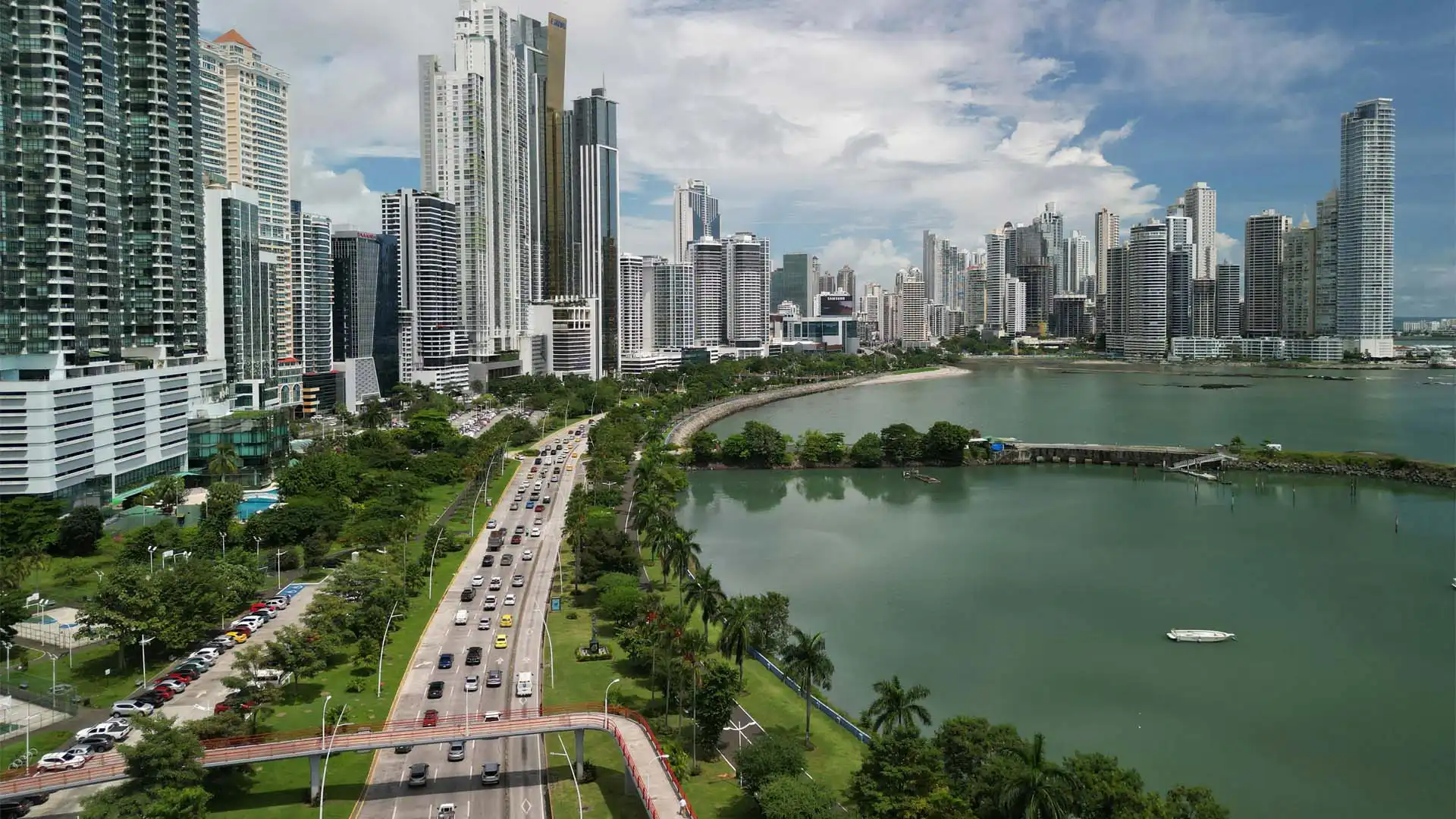 Vista aérea de la moderna ciudad de Panamá con rascacielos frente al mar y avenidas bordeadas de palmeras